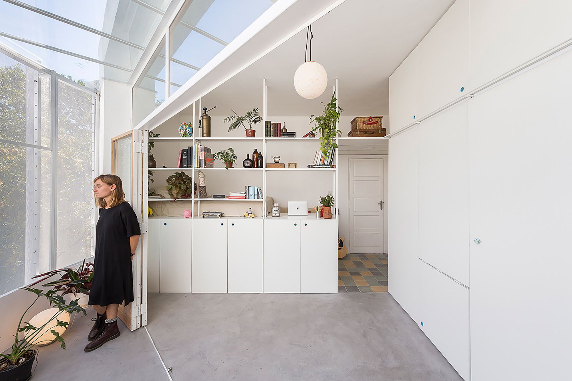 Corner Micro-Apartment Expanded With Clever Screened-In Living Space